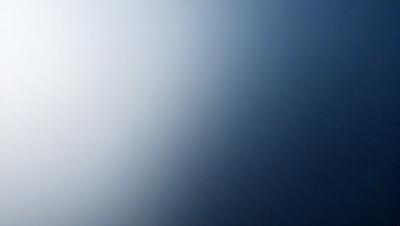 The primary subject of the image is a blue sky with a few clouds. The setting is a clear day with a cloudy sky. The visual style is a photo, and the colors and mood are predominantly blue and calm.