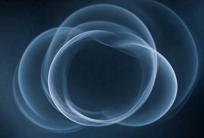 The primary subject of the image is a blue background with three white smoke rings or circles floating in the air. The setting appears to be a dark room, and the visual style is a combination of a photo and digital art. The circles have a slightly glowing effect, and the overall atmosphere is mysterious and intriguing.