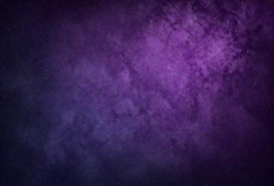 The primary subject of the image is a purple sky filled with stars. The setting is a dark, cloudy night, and the visual style is a photo of the night sky. The colors and mood of the image are predominantly purple and dark, creating a sense of mystery and wonder.