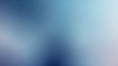 The primary subject of the image is a blue sky with a few clouds. The setting is a clear day with a cloudy sky. The visual style is a photo of the sky. The colors and mood are predominantly blue, creating a calm and serene atmosphere.