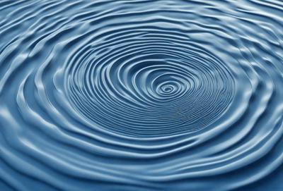 The primary subject of the image is a large, blue, circular wave. The wave is the main focus of the image, and it appears to be a natural, oceanic phenomenon. The setting is the ocean, with the wave being the central element in the scene. The visual style of the image is a close-up of the wave, emphasizing its size and shape. The dominant colors in the image are blue and white, creating a serene and calming atmosphere.