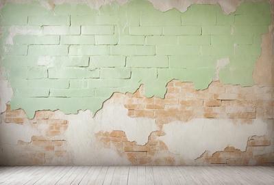 The primary subject of the image is a brick wall with a green and white color scheme. The setting is a room with a wooden floor. The visual style is a photo, and the colors and mood are predominantly green and white, giving the wall a clean and fresh appearance.