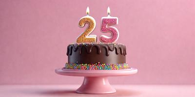 The primary subject of the image is a chocolate cake with white frosting and sprinkles. The cake is placed on a pink pedestal, which is situated on a pink surface. The setting appears to be a celebration or a special occasion, as the cake is decorated with a number twenty-five candle. The visual style of the image is a close-up, showcasing the details of the cake and its decorations. The colors and mood of the image are warm
