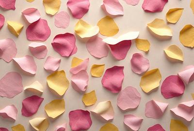 The primary subject of the image is a collection of pink and yellow flowers made from paper. These flowers are arranged in a pattern, covering a large surface. The setting is a white background, which provides a clean and uncluttered look. The visual style is a combination of digital art and illustration, as the flowers are created using paper and then digitally arranged. The colors and mood of the image are predominantly warm and cheerful, with the pink and yellow flowers evoking a sense of happiness and positivity.