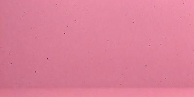 The primary subject of the image is a pink background with a pattern of dots. The setting is a close-up of the pink background, which creates a visually striking and unique visual style. The colors and mood of the image are predominantly pink, giving it a warm and inviting atmosphere.