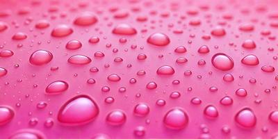 The primary subject of the image is a close-up of a pink surface with water droplets on it. The surface appears to be a pink background or a pink fabric. The water droplets are scattered all over the surface, creating a visually interesting and somewhat moist appearance. The visual style of the image is a close-up, which emphasizes the details of the water droplets and the pink surface. The colors and mood of the image are predominantly pink, which gives it a