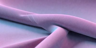 The primary subject of the image is a piece of purple fabric. The setting is a table, and the visual style appears to be a photo. The colors in the image are predominantly purple, creating a calm and soothing atmosphere.