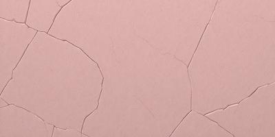 The primary subject of the image is a pink paper with a pattern of cracks and holes. The setting is a pink background, and the visual style is a close-up of the paper. The colors and mood of the image are predominantly pink, giving it a warm and inviting atmosphere.
