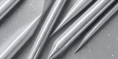 The primary subject of the image is a close-up of a pencil with a metallic sheen. The setting is a white background, which provides a clean and minimalistic appearance. The visual style is a combination of a photo and digital art, as the pencil appears to be a digital illustration. The colors and mood of the image are predominantly silver and gray, giving it a sleek and modern feel.