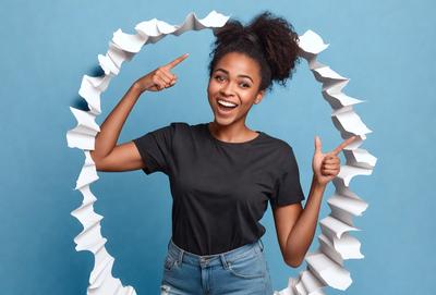 The primary subject of the image is a woman wearing a black shirt and jeans, with her arms raised and pointing upwards. She is smiling and appears to be enjoying herself. The setting is a blue background, which adds a vibrant and lively atmosphere to the scene. The visual style is a combination of a photo and a pattern, creating a unique and eye-catching image. The colors and mood are energetic and positive, with the woman's smile and raised arms conveying a sense
