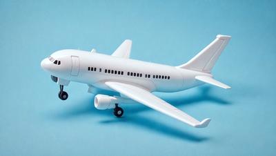 The primary subject of the image is a white model airplane. The airplane is placed on a blue surface, which serves as the background. The visual style of the image is a photo, capturing the details of the model airplane. The colors and mood of the image are predominantly blue and white, giving it a clean and modern appearance.