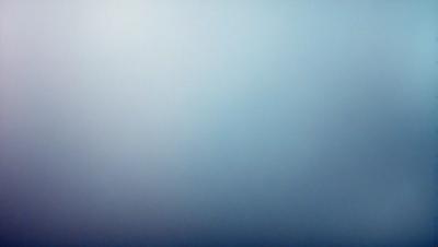 The primary subject of the image is a large, empty, and cloudy sky. The setting is a vast, open space with no visible landmarks or objects. The visual style is a natural, outdoor scene with a focus on the sky. The colors and mood of the image are predominantly blue, creating a calm and serene atmosphere.