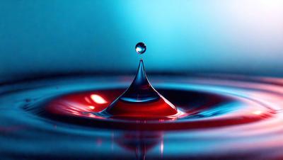 The primary subject of the image is a single drop of water, which is suspended in the air. The setting is a blue background, which creates a contrasting and visually appealing environment. The visual style is a close-up of the drop of water, emphasizing its details and texture. The colors and mood of the image are predominantly blue, which gives it a calm and serene atmosphere.