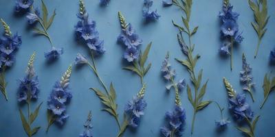The primary subject of the image is a collection of blue flowers arranged in a visually appealing manner. The flowers are displayed on a blue wall, creating a striking contrast between the flowers and the background. The visual style of the image is a combination of a photo and digital art, as it captures the beauty of the flowers while also showcasing the artist's creativity in arranging them. The colors and mood of the image are predominantly blue, which adds to the calming and serene atmosphere of the scene.