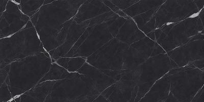 The primary subject of the image is a black marble countertop. The setting is a kitchen, with the countertop being the main focus of the scene. The visual style is a close-up of the marble countertop, showcasing its texture and pattern. The colors and mood of the image are predominantly dark, with the black marble countertop being the main source of contrast.