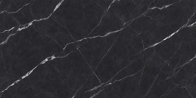 The primary subject of the image is a black marble countertop. The setting is a kitchen, with the countertop being the main focus of the scene. The visual style is a close-up of the marble countertop, showcasing its texture and pattern. The colors and mood of the image are predominantly dark, with the black marble providing a striking contrast against the surrounding environment.