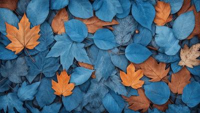 The primary subject of the image is a blue and orange leaf pattern. The setting is a blue and orange leaf-covered ground, which creates a visually appealing and vibrant atmosphere. The visual style of the image is a combination of photo and digital art, as it captures the intricate details of the leaves and their arrangement. The colors and mood of the image are predominantly blue and orange, with a sense of warmth and natural beauty.