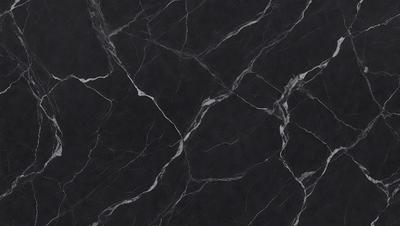 The primary subject of the image is a black marble countertop. The setting is a kitchen, with the countertop being the main focus of the scene. The visual style is a close-up of the marble countertop, showcasing its texture and pattern. The colors and mood of the image are predominantly dark, with the black marble countertop being the main source of contrast.