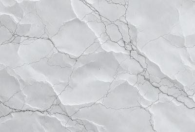 The primary subject of the image is a close-up of a marble wall with a white background. The setting is a marble wall, and the visual style is a photo. The colors and mood of the image are predominantly white, giving it a clean and elegant appearance.