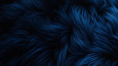 The primary subject of the image is a blue, furry object that appears to be a piece of fabric or a patterned surface. The setting is a dark background, which contrasts with the blue fabric. The visual style is a close-up of the blue fabric, showcasing its texture and pattern. The colors and mood of the image are predominantly blue, creating a calm and serene atmosphere.