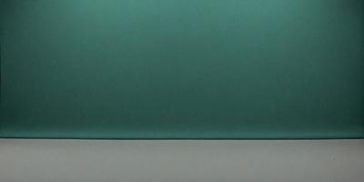 The primary subject of the image is a green leather surface. The setting is a wall, and the visual style is a photo. The colors and mood of the image are predominantly green, creating a calm and soothing atmosphere.