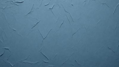 The primary subject of the image is a blue wall with a textured surface. The setting is a room with a blue background. The visual style is a close-up of the wall, showcasing its texture and color. The dominant colors are blue and grey, creating a calm and soothing atmosphere.