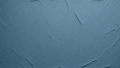 The primary subject of the image is a blue surface with a pattern of wrinkles and folds. The setting is a blue background, and the visual style appears to be a photo. The dominant colors are blue and white, creating a calm and serene atmosphere.