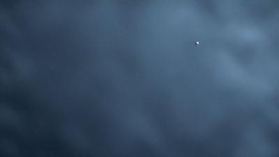 The primary subject of the image is a cloudy sky. The setting is a dark, cloudy day with a gloomy atmosphere. The visual style is a photo, capturing the natural beauty of the cloudy sky. The colors and mood are predominantly dark and moody, with the clouds being the main focus of the image.