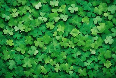 The primary subject of the image is a close-up of a green plant with many leaves. The plant is surrounded by a lush green background, creating a vibrant and natural atmosphere. The visual style of the image is a photo, capturing the intricate details of the plant and its leaves. The colors and mood of the image are predominantly green, with a sense of freshness and vitality.