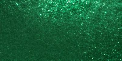 The primary subject of the image is a green background with a pattern of glittering stars. The setting appears to be a dark room, and the visual style is a combination of a photo and digital art. The colors and mood of the image are predominantly green, with a sense of depth and sparkle from the stars.