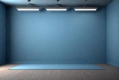 The primary subject of the image is a large blue wall with a blue background. The setting is a room with a wooden floor. The visual style is a photo, and the colors and mood are predominantly blue, creating a calm and serene atmosphere.
