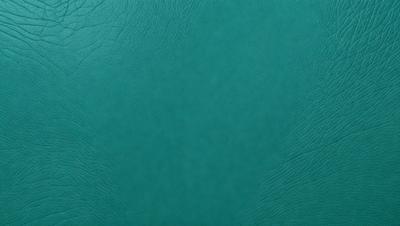 The primary subject of the image is a close-up of a green leather book cover. The setting is a table, and the visual style is a photo. The dominant colors are green and white, creating a calm and soothing atmosphere.