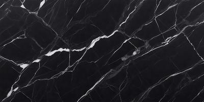 The primary subject of the image is a black marble countertop with white veins. The setting is a kitchen, and the visual style is a close-up of the marble countertop. The dominant colors are black and white, creating a sleek and modern atmosphere.