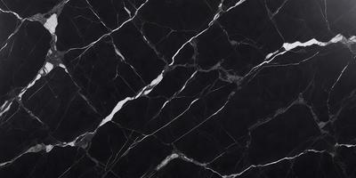 The primary subject of the image is a black marble countertop. The setting is a kitchen, with the countertop being the main focus of the scene. The visual style is a close-up of the marble countertop, showcasing its texture and pattern. The colors and mood of the image are predominantly black, giving it a sleek and modern appearance.