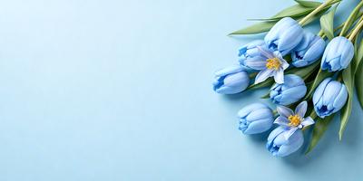 The primary subject of the image is a bouquet of blue flowers, which are the main focus of the scene. The flowers are placed on a blue surface, which serves as the background. The visual style of the image is a photo, capturing the beauty of the flowers in their natural setting. The dominant colors in the image are blue and white, creating a calm and serene atmosphere.