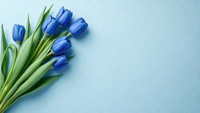 The primary subject of the image is a bouquet of blue flowers, which are the main focus of the scene. The flowers are placed against a blue wall, creating a visually appealing contrast. The visual style of the image is a photo, capturing the beauty of the flowers in their natural setting. The dominant colors in the image are blue and white, giving the scene a calm and serene atmosphere.