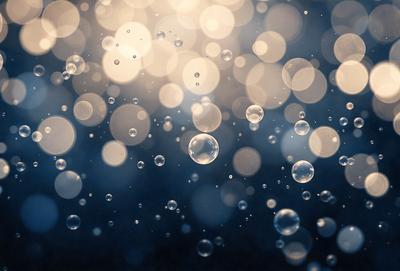 The primary subject of the image is a close-up of a bubble, which is the main object in the scene. The setting is a dark background, creating a contrast with the bubble. The visual style is a close-up of a single bubble, emphasizing its texture and details. The colors in the image are predominantly blue, giving the scene a calm and serene atmosphere.