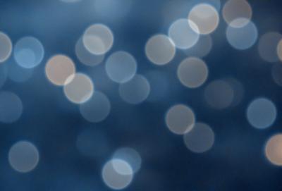The primary subject of the image is a blue background with a pattern of white lights or stars. The setting appears to be a night sky, and the visual style is a combination of a photo and digital art. The colors are predominantly blue and white, creating a serene and calming atmosphere.