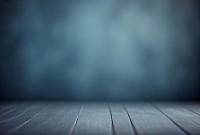 The primary subject of the image is a wooden floor with a blue background. The setting appears to be a room with a blue wall. The visual style is a photo, and the colors and mood are predominantly blue, creating a calm and serene atmosphere.