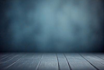 The primary subject of the image is a wooden floor with a blue background. The setting appears to be a room with a blue wall. The visual style is a photo, and the colors and mood are predominantly blue, creating a calm and serene atmosphere.