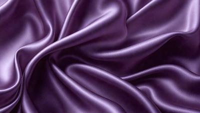 Purple fabric, possibly silk, with a flowing and curling pattern.