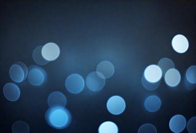 The primary subject of the image is a blue background with a pattern of white lights. The setting appears to be a dark room, and the visual style is a combination of a photo and digital art. The dominant colors are blue and white, creating a calm and serene atmosphere.