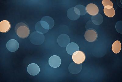 The primary subject of the image is a blue background with a pattern of white lights. The setting appears to be a nighttime scene, possibly a cityscape or a dark room with a light source. The visual style of the image is a combination of a photo and digital art, creating a unique and artistic representation of the scene. The dominant colors are blue and white, with the white lights creating a sense of depth and contrast against the dark blue background. The overall atmosphere of the image is serene and captivating.