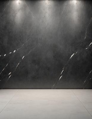 The primary subject of the image is a large, gray stone wall. The setting is a room with a white floor, and the visual style is a photo. The dominant colors are gray and white, creating a calm and minimalist atmosphere.