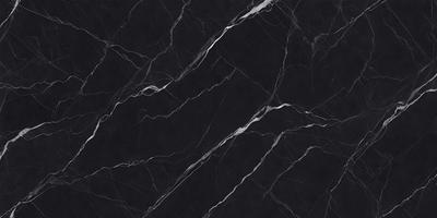 The primary subject of the image is a black marble countertop. The setting is a kitchen, with the countertop being the main focus of the scene. The visual style is a close-up of the marble countertop, showcasing its texture and pattern. The colors and mood of the image are predominantly dark, with the black marble countertop being the main source of contrast.