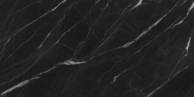 The primary subject of the image is a close-up of a marble countertop. The setting is a kitchen, with the marble countertop being the main focus of the scene. The visual style is a photo, showcasing the natural texture and beauty of the marble. The colors and mood of the image are predominantly black, giving it a sleek and modern appearance.