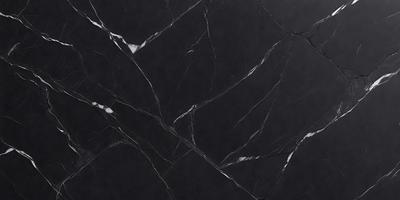 The primary subject of the image is a black marble countertop. The setting is a kitchen, with the countertop being the main focus of the scene. The visual style is a close-up of the marble countertop, showcasing its texture and pattern. The colors and mood of the image are predominantly dark, with the black marble countertop being the main source of contrast.