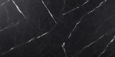 The primary subject of the image is a black marble countertop. The setting is a kitchen, with the countertop being the main focus of the scene. The visual style is a close-up of the marble countertop, showcasing its texture and pattern. The colors and mood of the image are predominantly dark, with the black marble countertop being the main source of contrast.
