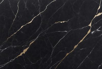 The primary subject of the image is a black marble countertop with gold accents. The setting is a kitchen or bathroom, as the countertop is a part of a counter. The visual style is a close-up of the marble countertop, showcasing its texture and design. The colors and mood of the image are predominantly black and gold, giving it a luxurious and elegant appearance.