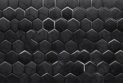 The primary subject of the image is a black and white patterned surface, which appears to be a tile or a wall with a hexagonal pattern. The setting is a black and white photo, which gives the image a classic and timeless feel. The visual style is a close-up of the pattern, showcasing the intricate details of the hexagonal design. The colors and mood of the image are predominantly black and white, creating a sense of depth and contrast.